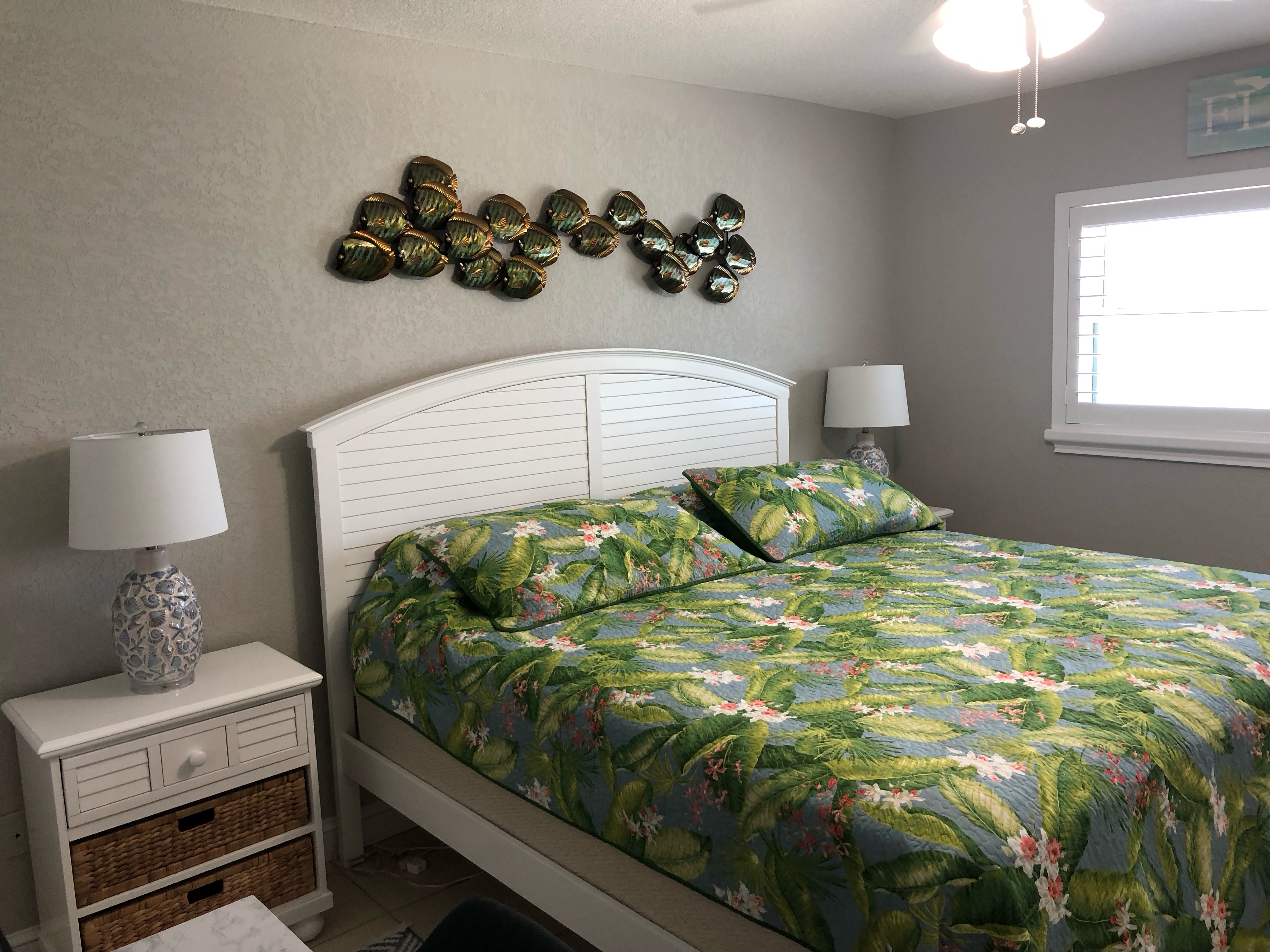 Master bedroom with a large king size bed and desk/chair with a pluggable monitor.