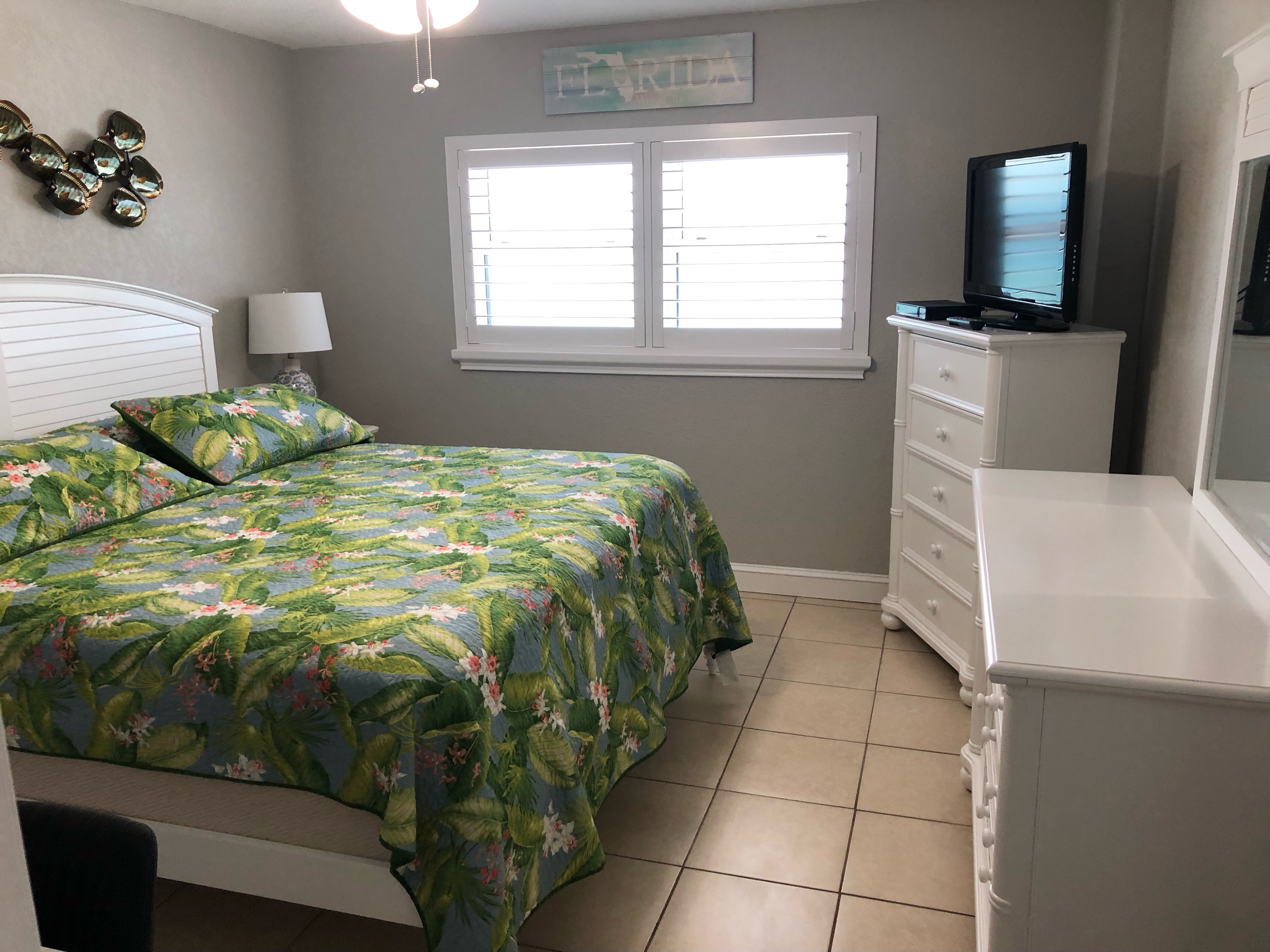 Master bedroom with a mid size storage closet, dresser and a chest with cable enable TV.